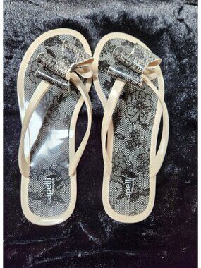 Capelli New York Ladies Floral Pom Opaque Jelly Flip Flops-Beige Black - SZ 10